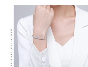Macro detail of multi-row pavé cubic zirconia on s925 silver cuff bracelet worn on wrist