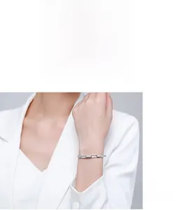 Detailed close-up of s925 silver bracelet with pavé cubic zirconia worn by model