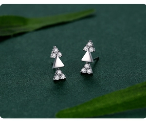Macro shot of S925 sterling silver triangle earrings with sparkling zircons