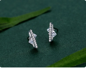 Close-up of S925 sterling silver stud earrings with square and triangle zircon accents
