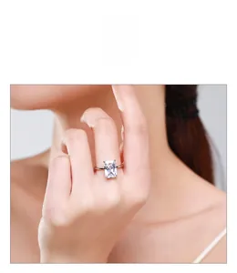 Detail of s925 silver ring with emerald-cut zircon on model hand with a macro view