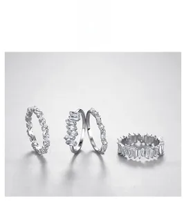 Detailed view of four S925 sterling silver rings with baguette and round cut zircons