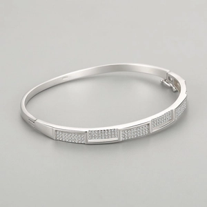 Elegant S925 sterling silver open bangle with pavé crystal sections in a minimalist style