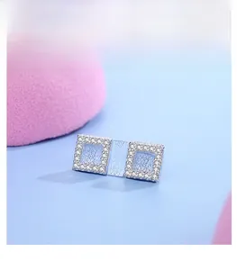 Macro detail of square S925 silver stud earrings with sparkling pave-set white zircons