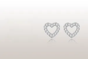 Macro view of S925 sterling silver hollow heart stud earrings with cubic zirconia inlay