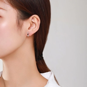 Elegant S925 sterling silver triangle stud earrings with zircons on model ear