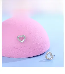 Close-up of s925 silver hollow heart stud earrings with sparkling pavé micro-inlaid stones
