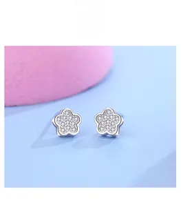 Macro detail of S925 sterling silver flower earrings with sparkling pavé cubic zirconia