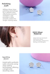 Detailed view of S925 sterling silver floral studs with cubic zirconia and polished finish