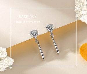 Macro shot of S925 sterling silver long drop earrings with triangle zircon stud and cone charm