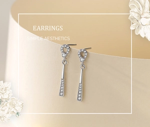 Macro view of S925 silver drop earrings featuring pavé cubic zirconia and geometric rings