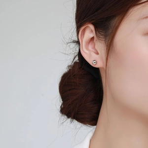 Minimalist S925 sterling silver bubble stud earrings on model with polished finish