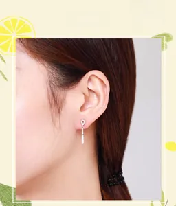 Model wearing S925 silver geometric drop earrings with sparkling pavé cubic zirconia details