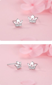 Macro detail of S925 silver crown stud earrings with sparkling white cubic zirconia