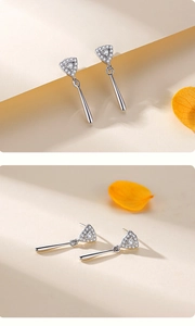 Macro detail of S925 silver geometric earrings with pavé stones and sleek long drop