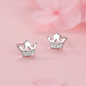 S925 sterling silver crown stud earrings with sparkling cubic zirconia on pink background
