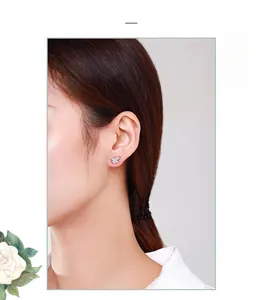 Close-up of geometric S925 silver stud earrings with sparkling pave zircon on model