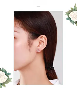 Close-up of s925 silver heart cupid arrow stud earring with micro-pave crystals on ear