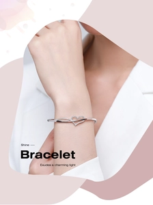 Close-up of elegant S925 silver heart bracelet with sparkling zircons on female wrist