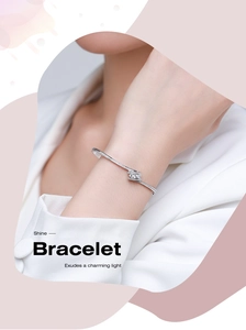 Close-up of twisted S925 silver bracelet with pavé cubic zirconia on a wrist