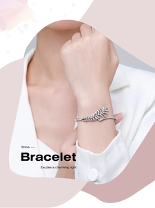 Detailed view of silver leaf bracelet with sparkling cubic zirconia on a female model