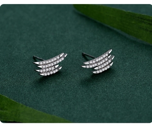 Macro shot of S925 silver geometric layered studs with micro-paved zircons