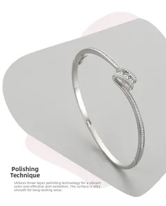 Detailed shot of polished s925 silver cuff with sparkling zircon accents and twisted design