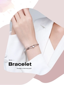 Detalle de una pulsera de plata de doble capa con diamante central lucida por modelo