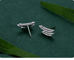 Macro detail of S925 sterling silver curved stud earrings with triple row pavé diamonds