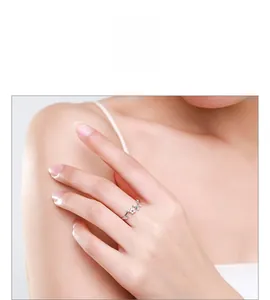 Detail of adjustable S925 silver flower ring with micro-paved cubic zirconia on model