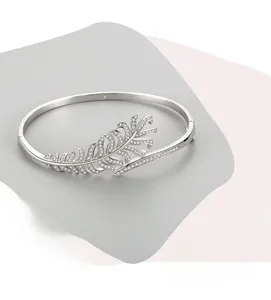 Close-up of S925 sterling silver feather open bangle with sparkling pavé cubic zirconia