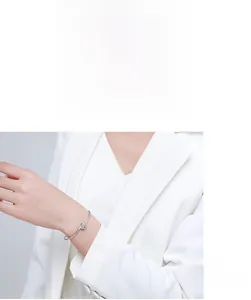 Minimalist s925 silver cuff bracelet with sparkling diamonds worn on woman's wrist