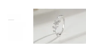 Detailed macro view of silver flower ring with micro-paved cubic zirconia and polished finish