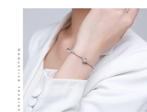 Detail of s925 silver open bracelet featuring micro-pave cubic zirconia on a double twist