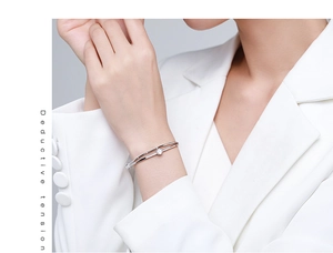Detalle de una pulsera abierta de doble capa en plata S925 con una piedra central brillante