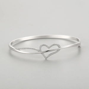 Elegant s925 silver open heart bangle with zircon pavé accents on light grey background