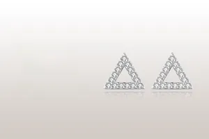 Macro detail of geometric triangle earrings with pave-set cubic zirconia on silver