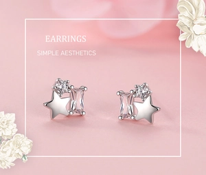 Close-up of S925 silver star earrings with sparkling cubic zirconia on pink background