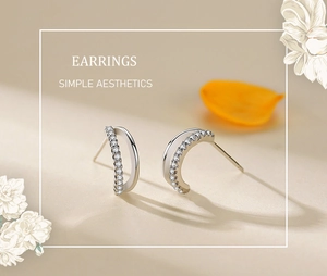 Close-up of silver S925 earrings featuring double curved layers with sparkling zircon stones