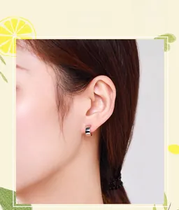 Close-up of minimalist S925 sterling silver C-shaped stud earrings on model's ear