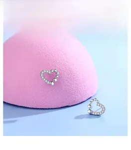 Detail of s925 silver heart stud earrings with cubic zirconia and silver beads finish