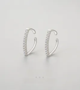 Macro detail of S925 sterling silver ear cuff with shimmering pavé micro-inlaid stones