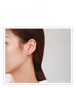 Close-up of s925 silver stud earrings featuring a vertical cubic zirconia row on an ear