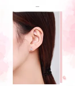 Detail of S925 sterling silver petal stud earrings with cubic zirconia on model's ear