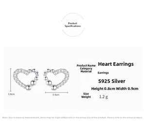 Macro shot of S925 silver heart stud earrings with cubic zirconia stones and beaded edges