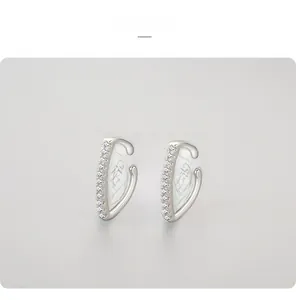 Detail of C-shaped S925 sterling silver ear cuffs with sparkling round cubic zirconia