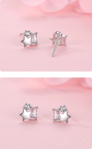 Detail of S925 silver star earrings featuring sparkling cubic zirconia stones in soft light