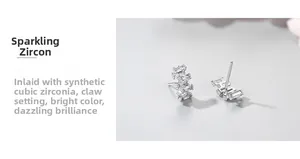 Macro detail of S925 silver stud earrings with claw-set cubic zirconia stones