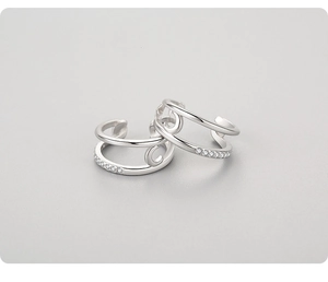 Detail of 925 sterling silver ear cuffs with moon star design and zircon pavé inlay