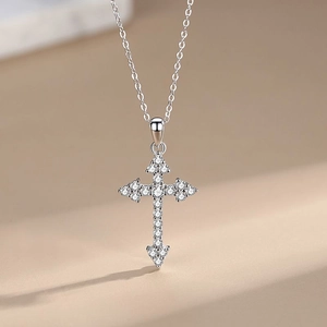 925 sterling silver cross necklace with pavé cubic zirconia on a warm background